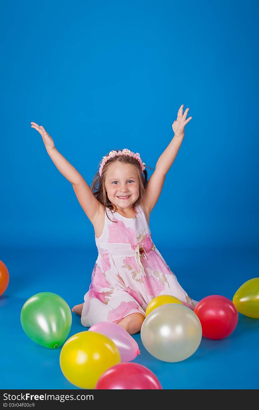 Happy Child With Colorful Air Ballons Over Blue