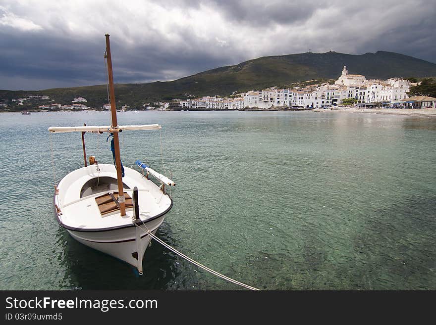 Not usual view of cadaques with a lonely boat in left hand.