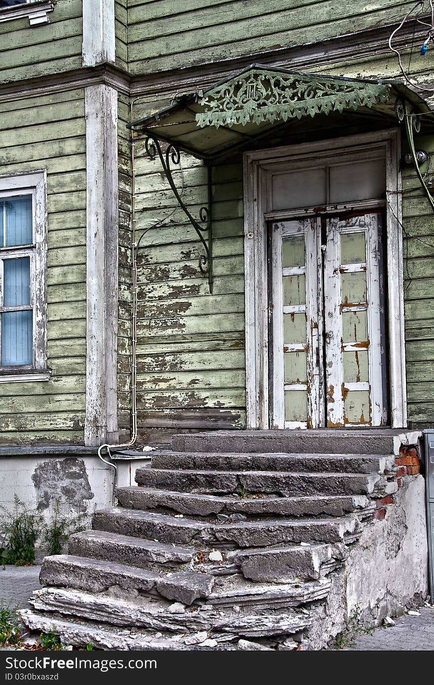 Derelict steps and entrance door to old wooden house that has seen better days. Derelict steps and entrance door to old wooden house that has seen better days.