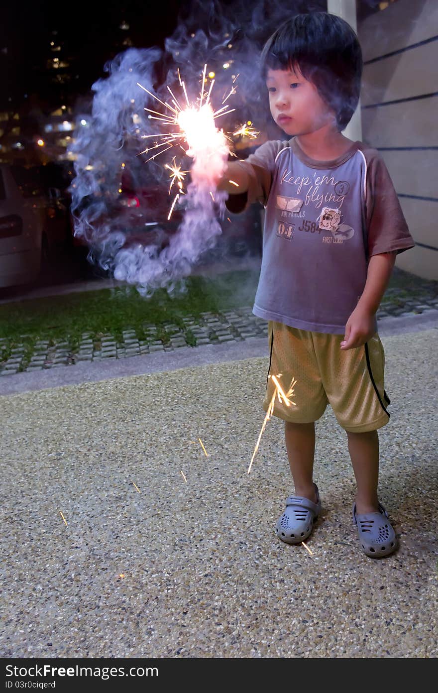 Engross Asian boy playing with fire crackers. Engross Asian boy playing with fire crackers