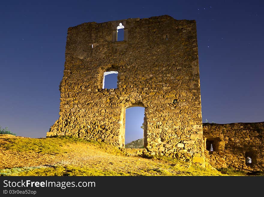 Low-angle shoot of old ruins of a castle at night. Low-angle shoot of old ruins of a castle at night