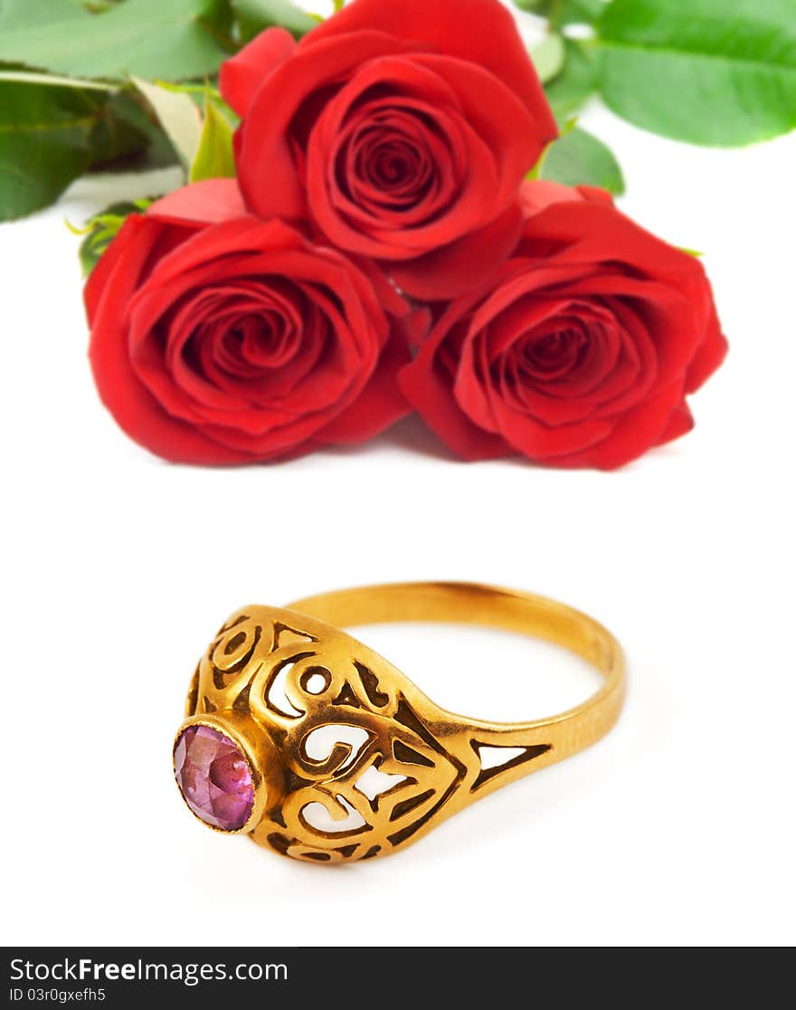 Roses and golden ring isolated on white background