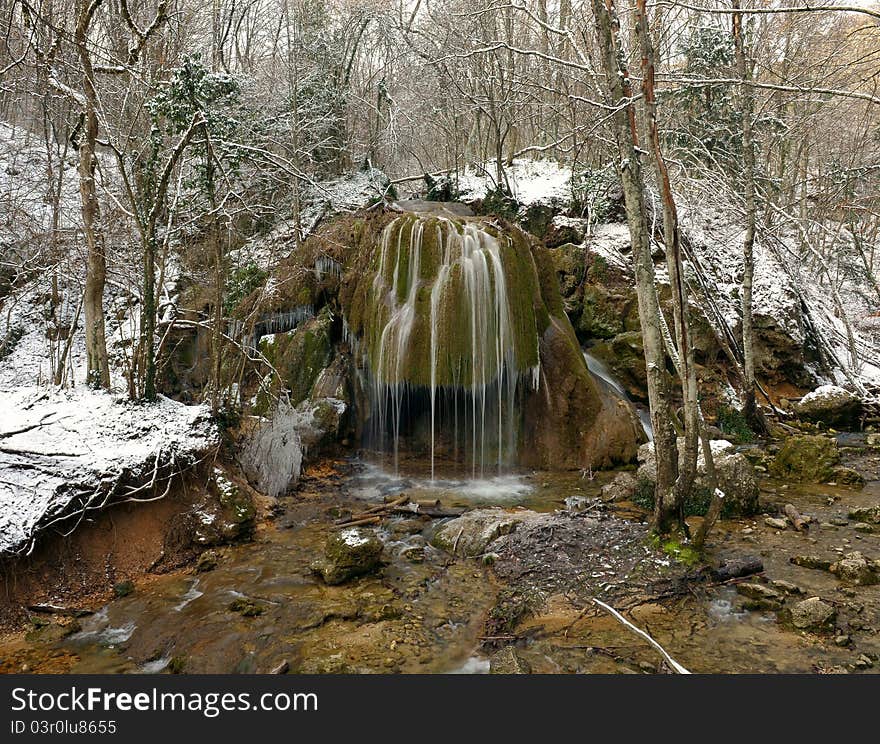 Falls in the winter forest