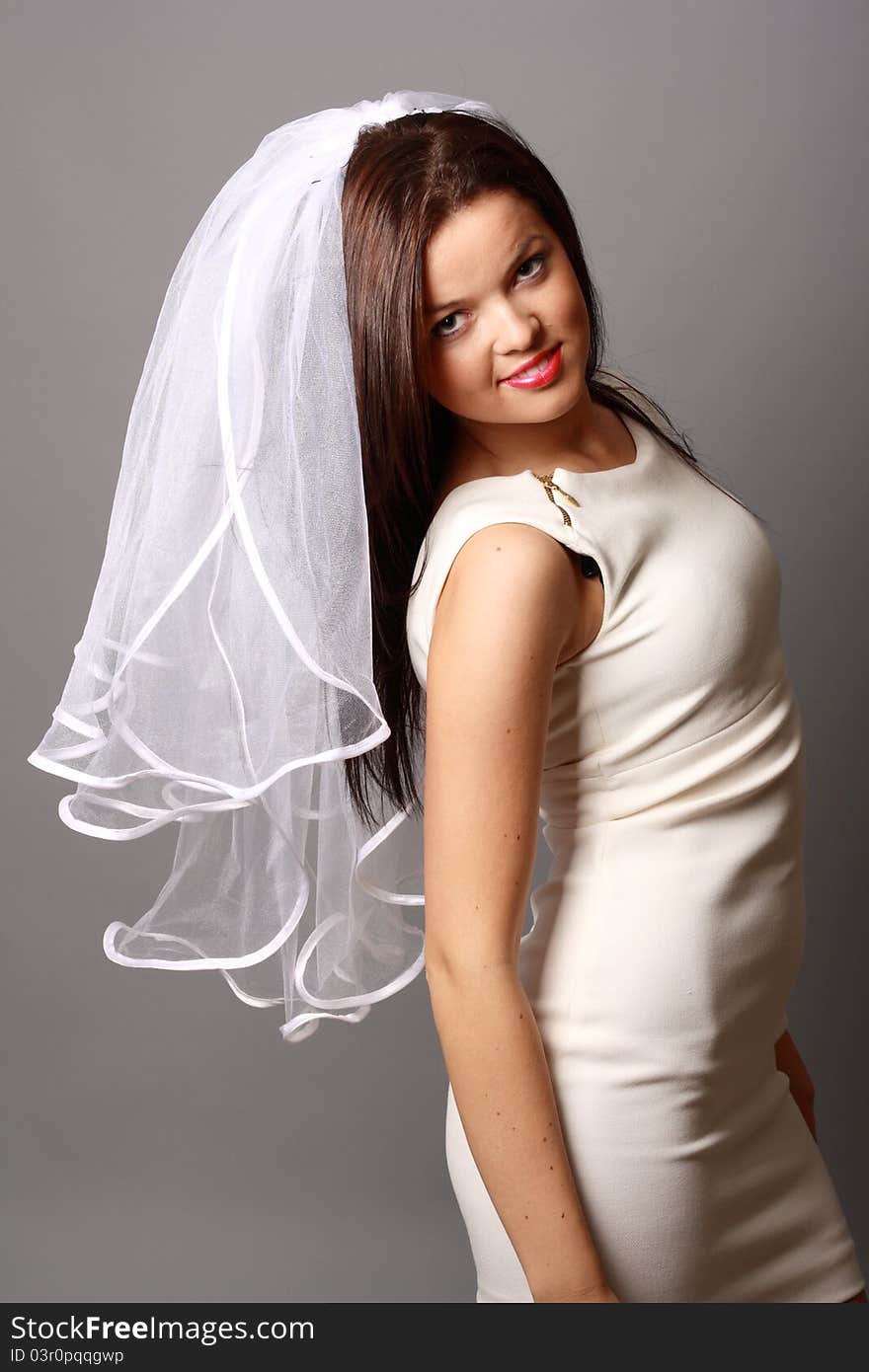 Beautiful young girl in a beautiful dress and white veil