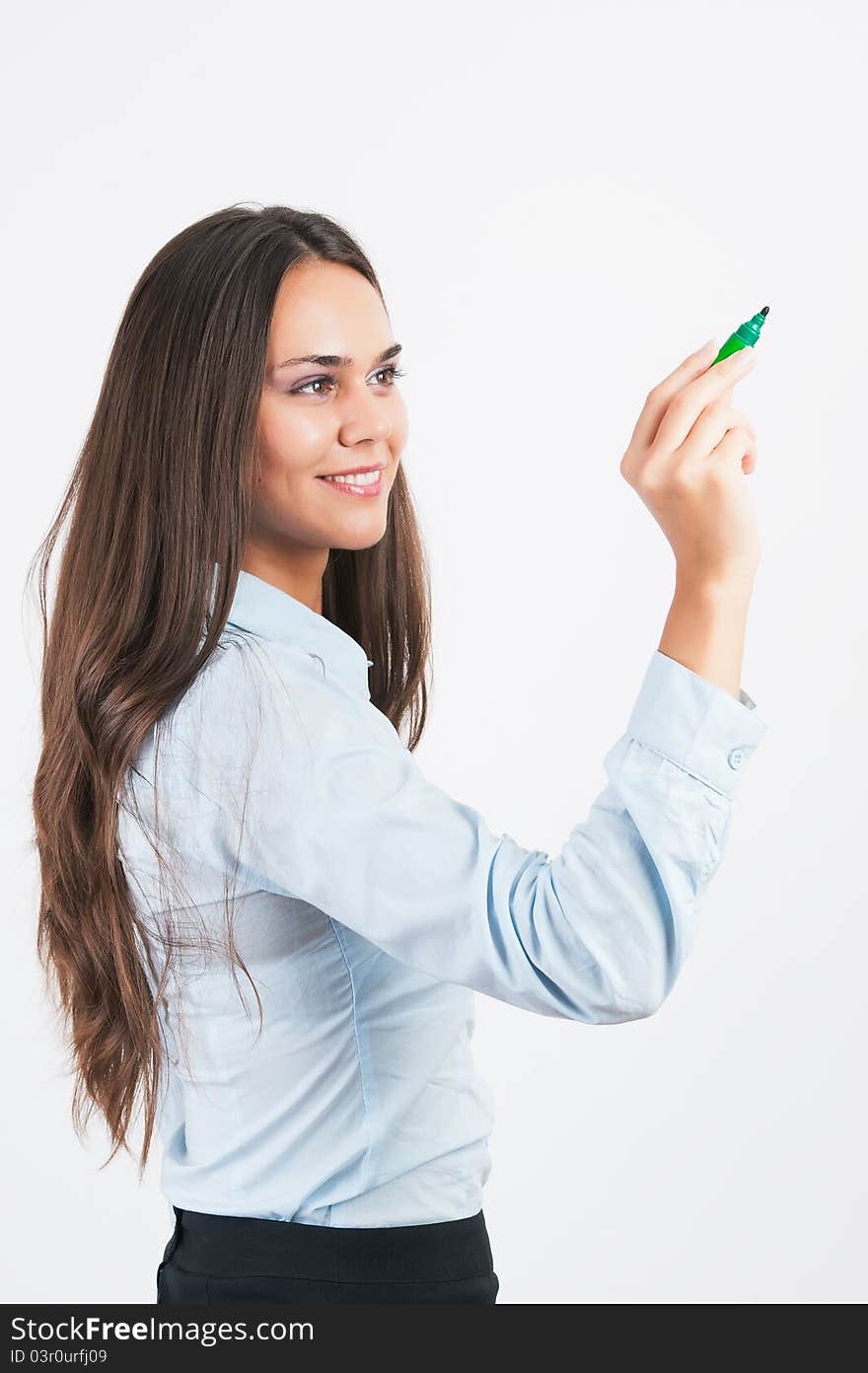 Happy smiling cheerful young business woman writing or drawing on screen with green marker, on white background