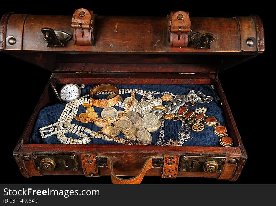 A trunk full of coins and precious jewelry. A trunk full of coins and precious jewelry