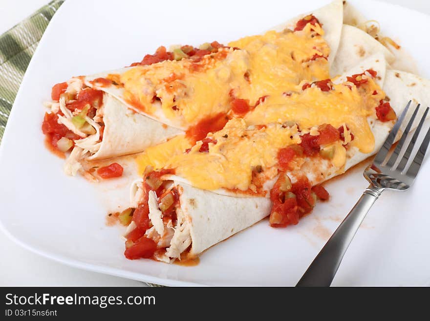 Two chicken fajitas covered with cheese sauce. Two chicken fajitas covered with cheese sauce