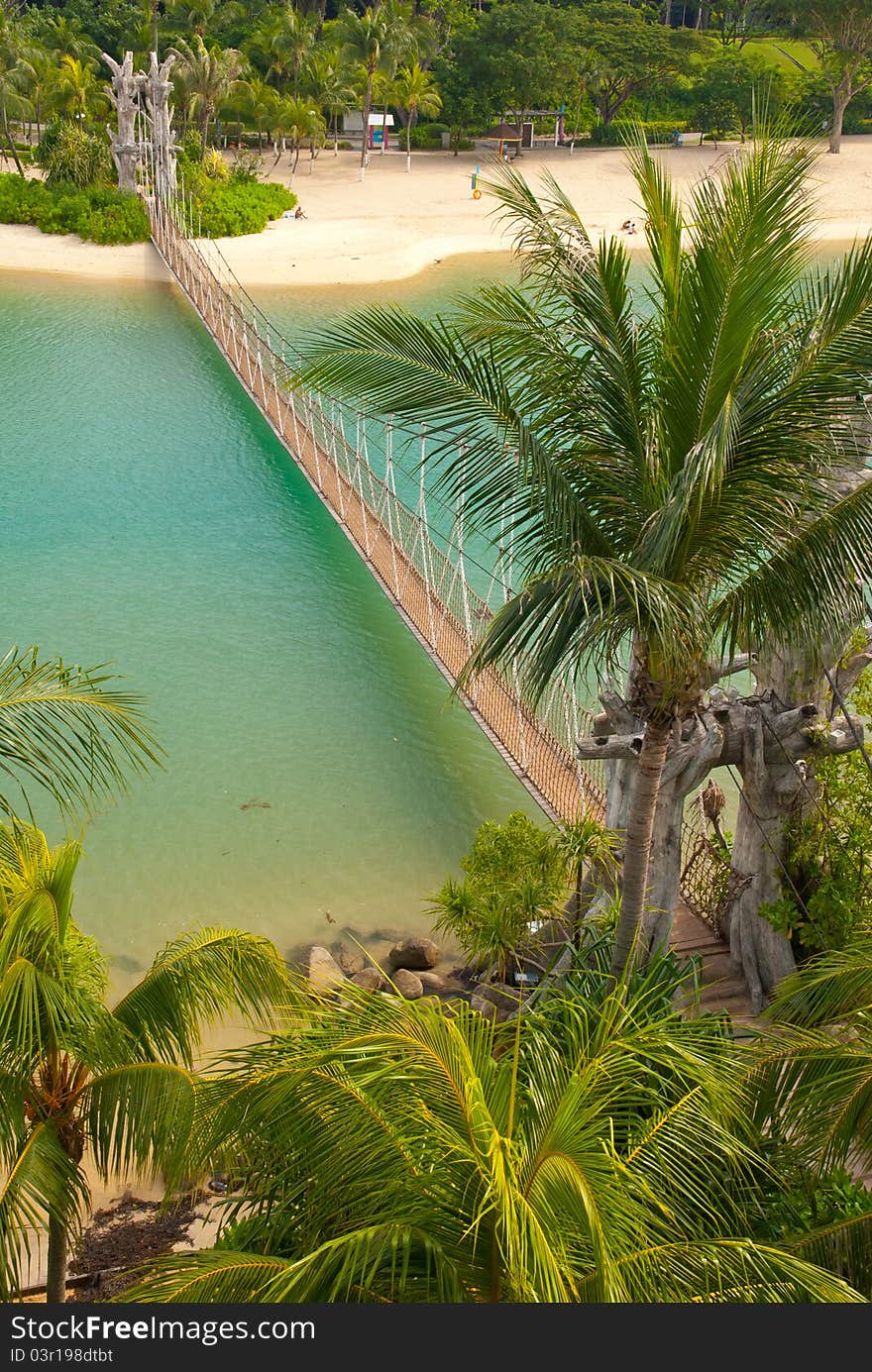 Top down view of wooden suspension bridge leading to beautiful resort island. Top down view of wooden suspension bridge leading to beautiful resort island.