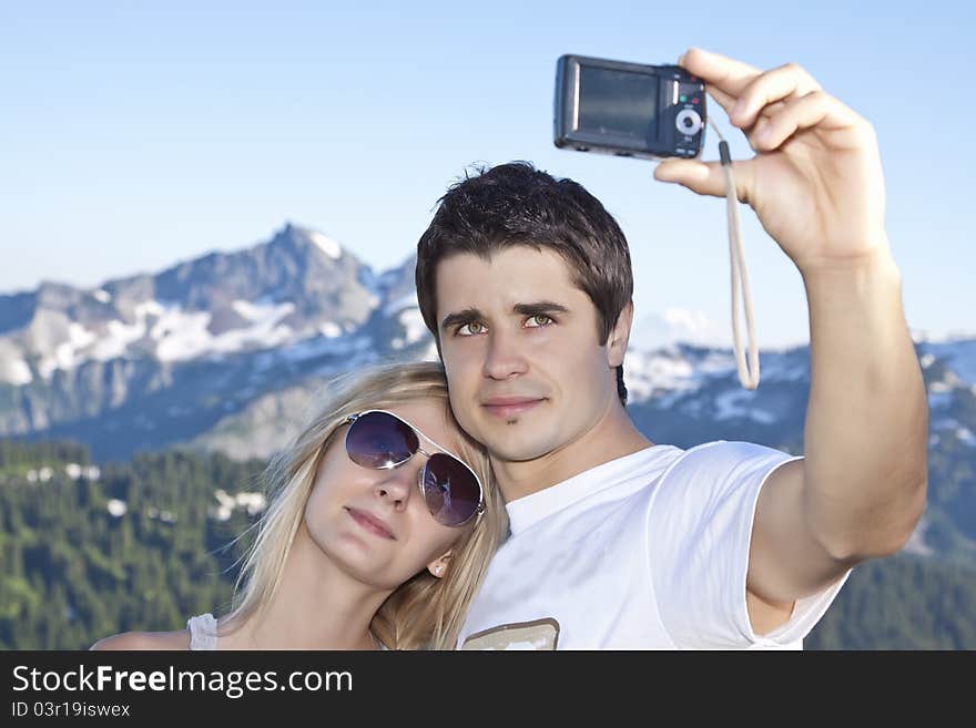 Portrait of a young happy couple together on the mount photographed themselves. Portrait of a young happy couple together on the mount photographed themselves