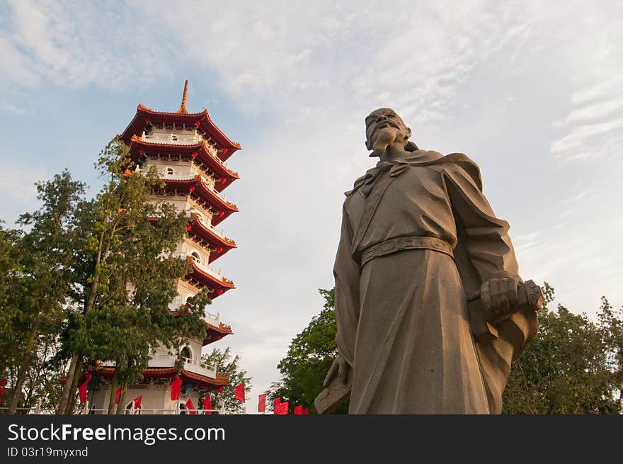 Historical Chinese statue and traditional Oriental pagoda in Chinese Garden. Historical Chinese statue and traditional Oriental pagoda in Chinese Garden.