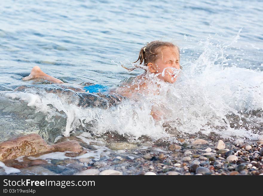 Beautiful girl lying at the seashore