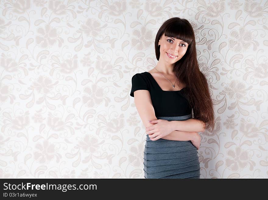 Confident woman with arms crossed against a light background