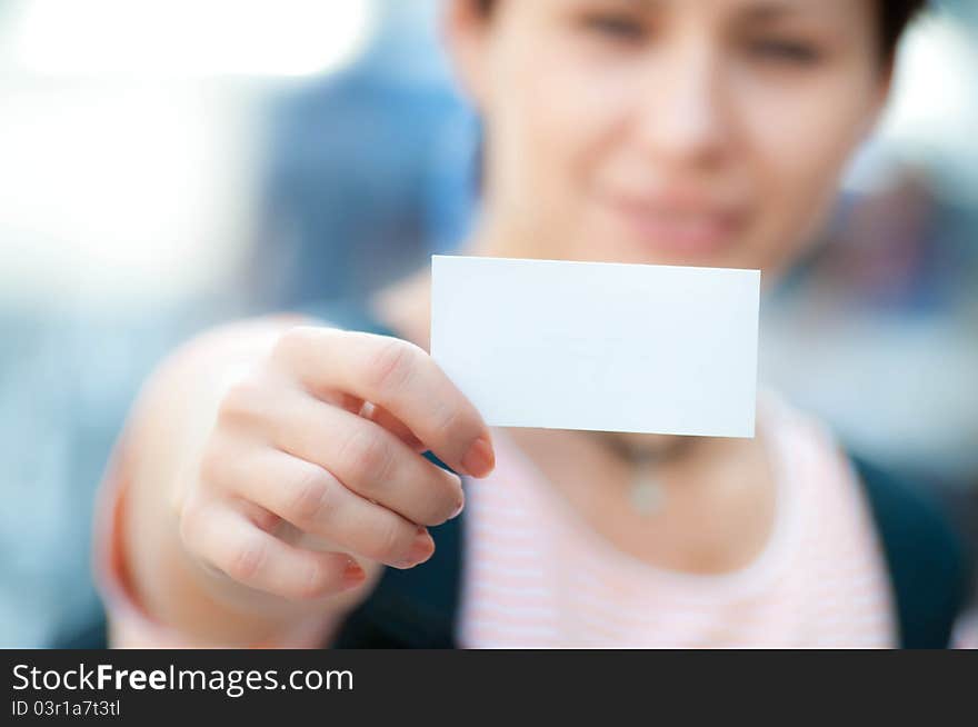 White card in a hand on a blur background