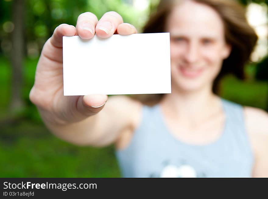 White card in a hand on a blur background