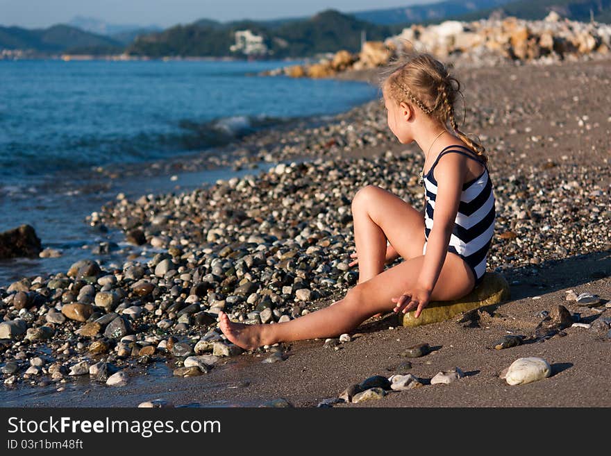 Beautiful girl sitting on a beach