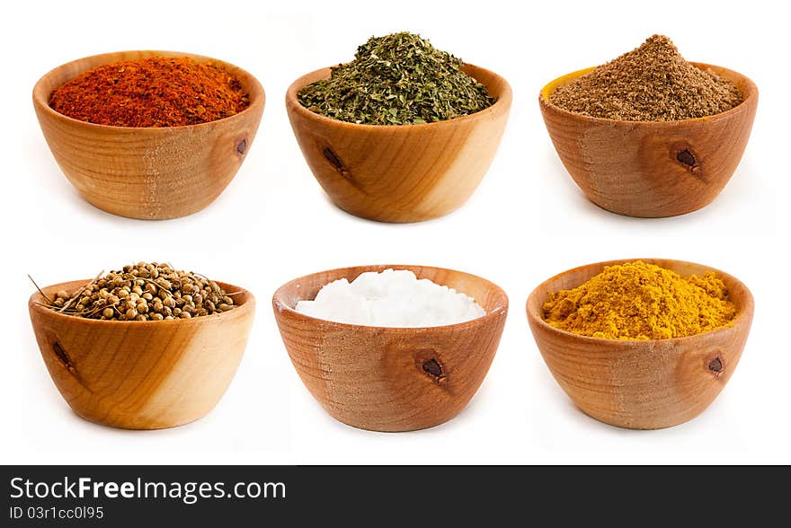 Spices in a wooden platter isolated on a white background