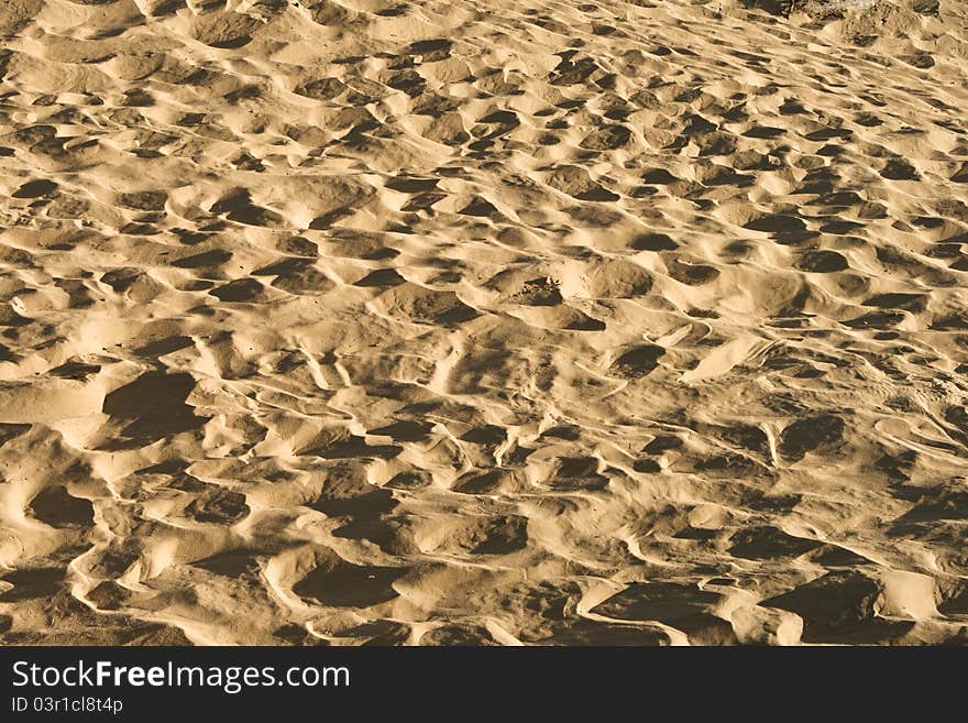 Sand background with traces of feet