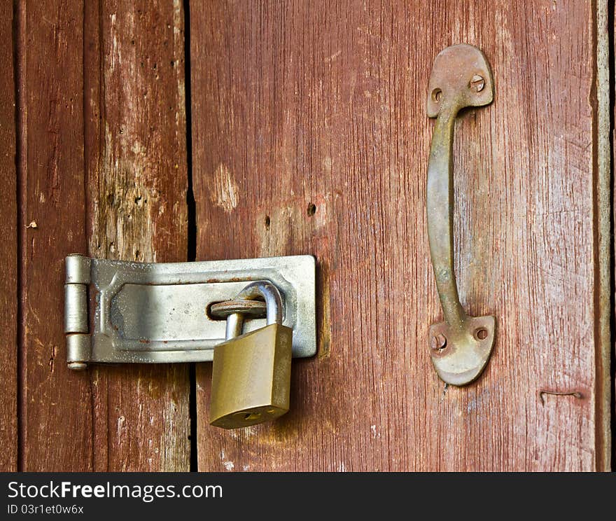 The old locked on wooden door