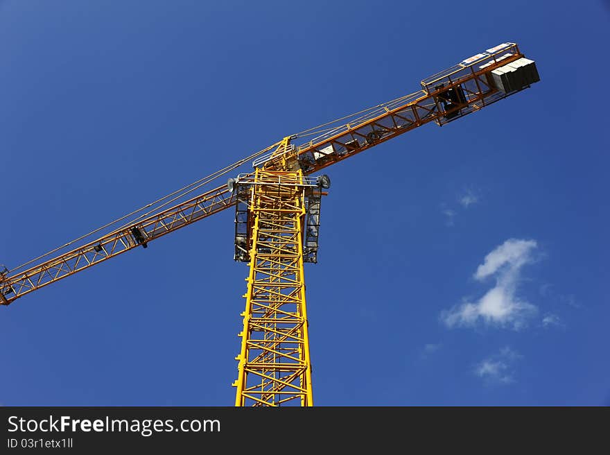 Tower crane in the blue sky