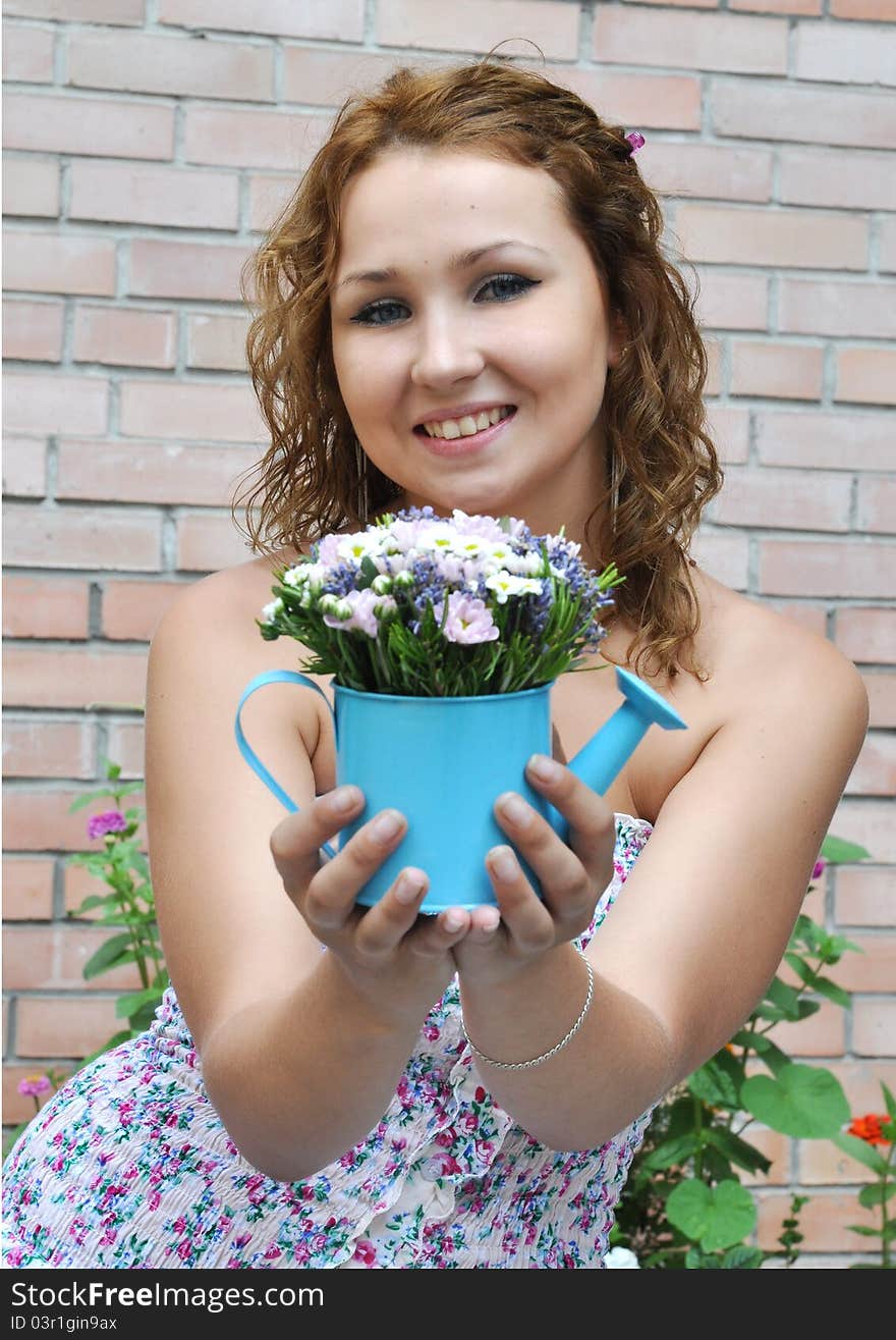 Attractive young girl with flower bouquet