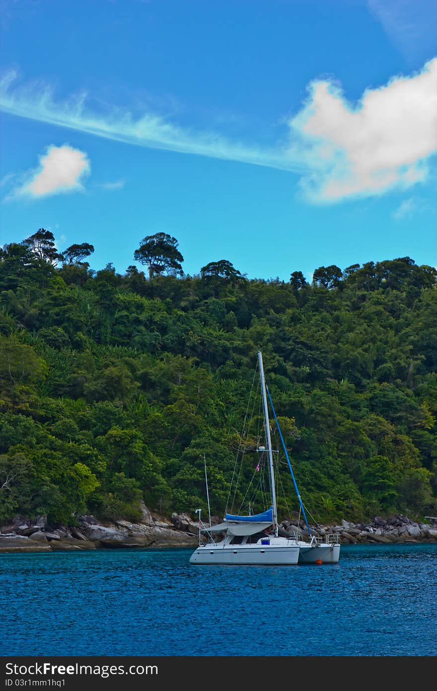 Beautiful white sail boat with island background. Beautiful white sail boat with island background