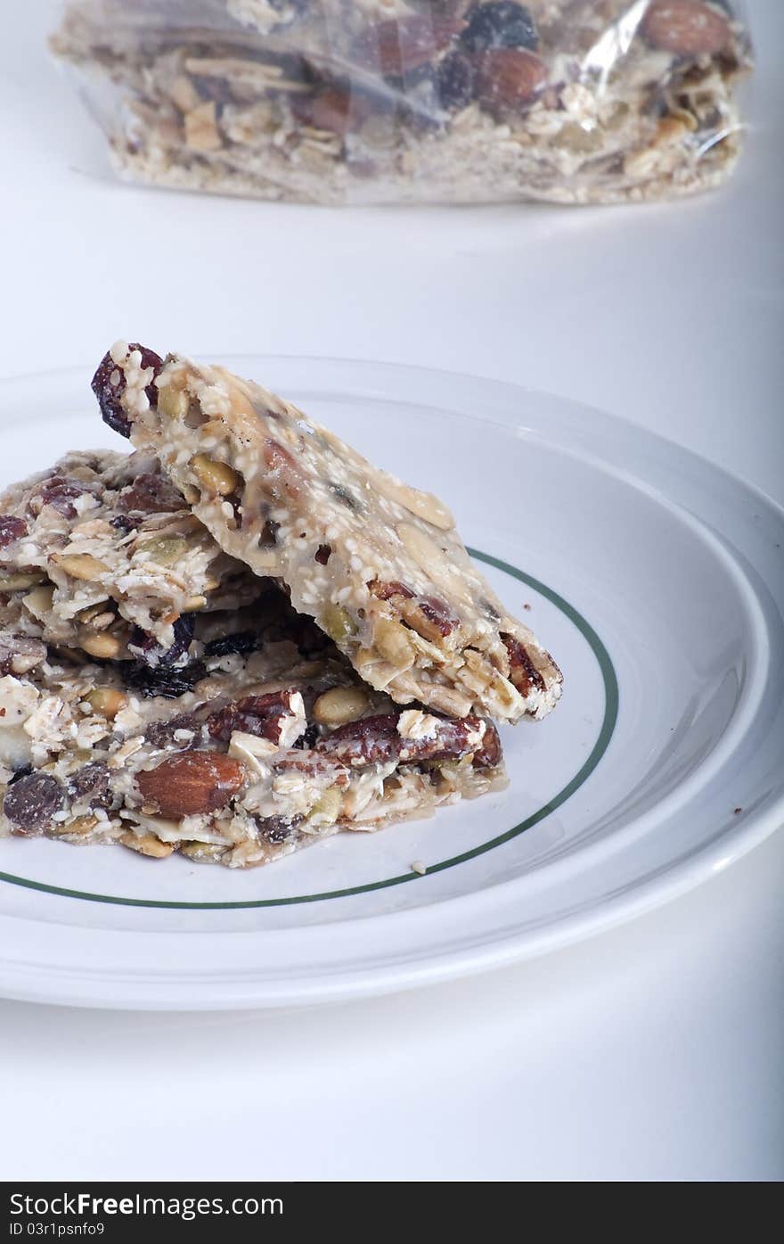 Granola Bark Treat on a dish with bag in background.