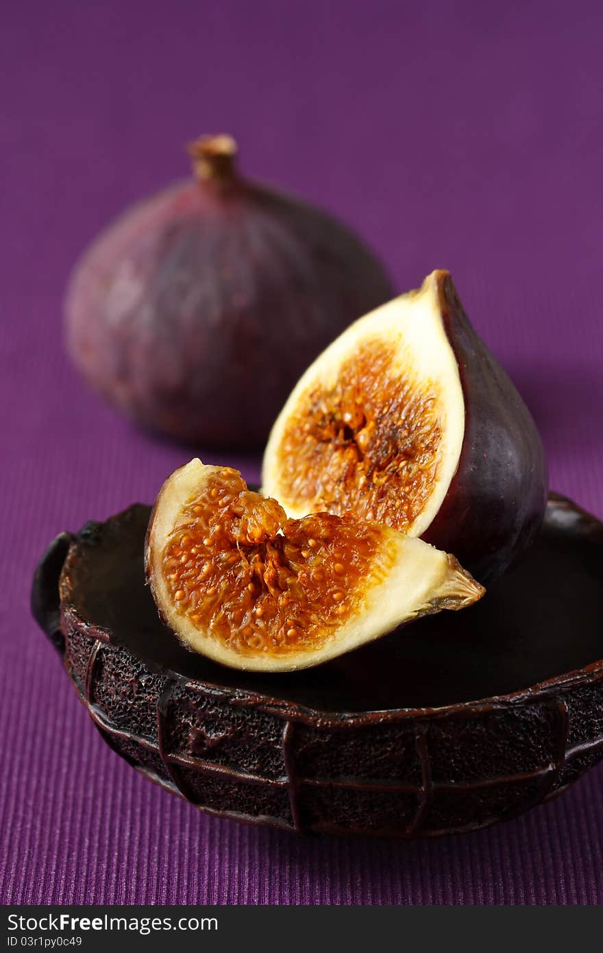 Delicious ripe figs on the purple fabric. Delicious ripe figs on the purple fabric.