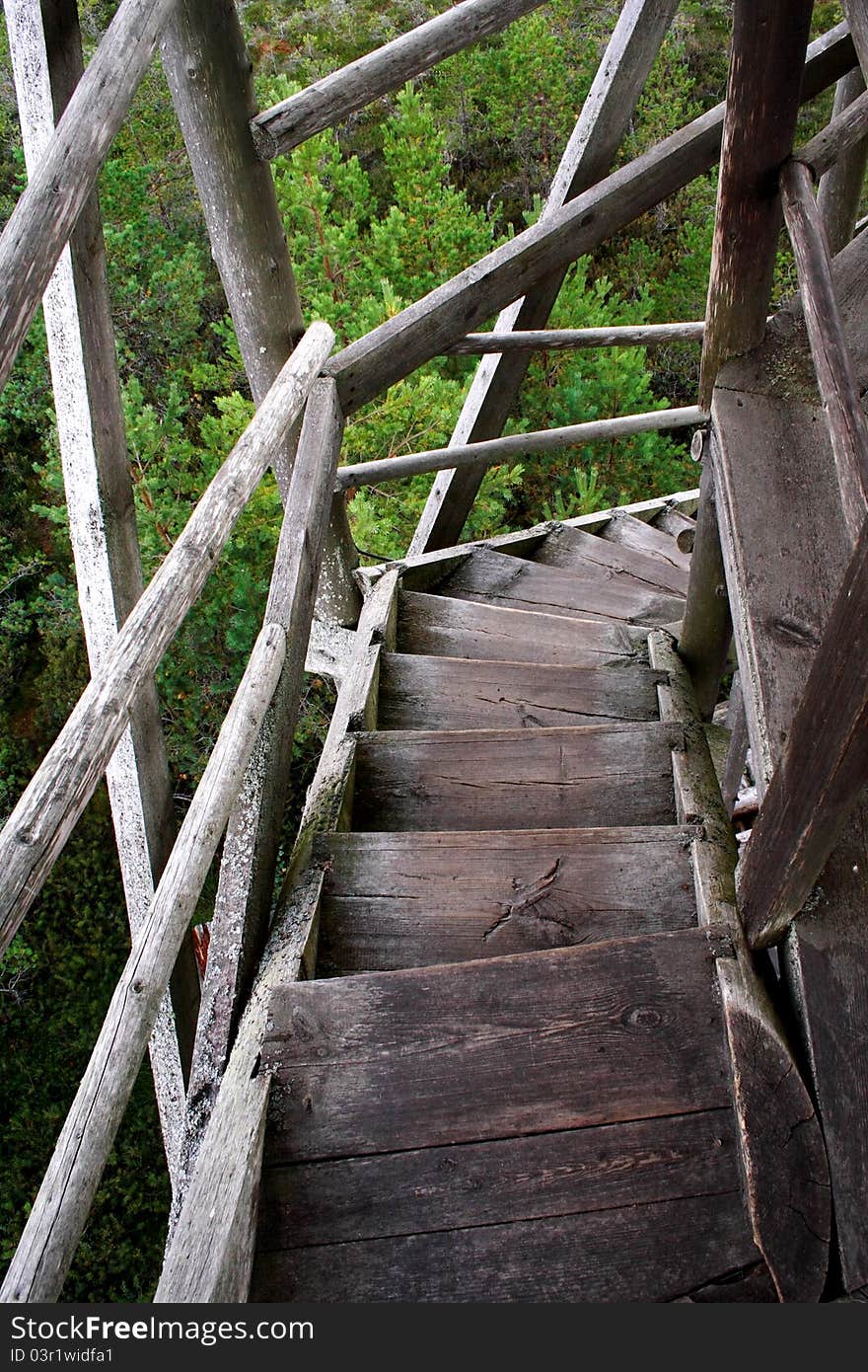 Wheathered wood stairs leading down till the ground