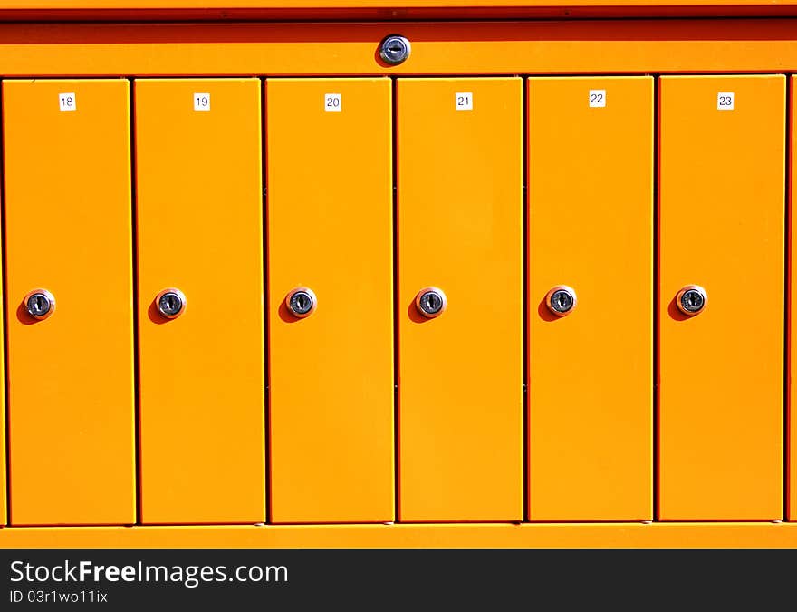 Yellow letterboxes maded from steel have stainless locks