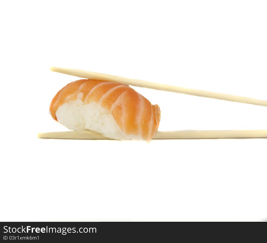 Nigiri sushi with salmon between two chopsticks