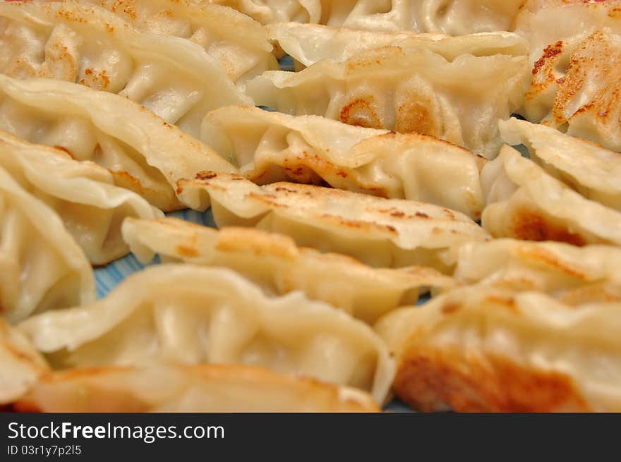 Fried Chinese dumplings on plate background