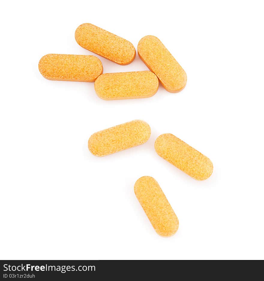 Orange medical pills isolated on white