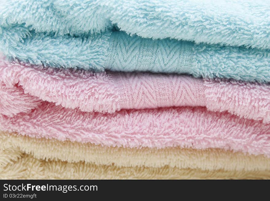 Different shades of towels stacked on each other