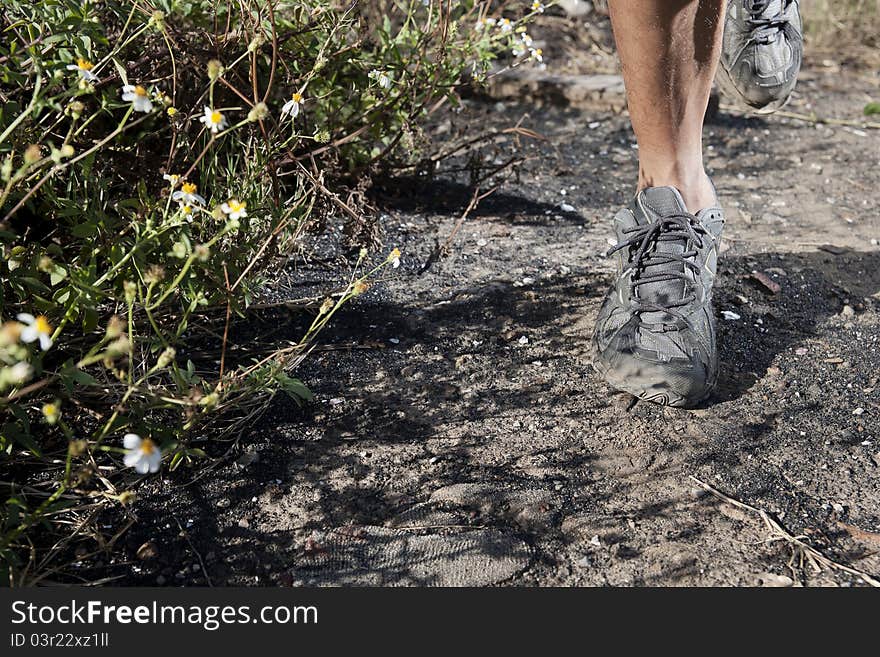 Jogger running in desert .close up