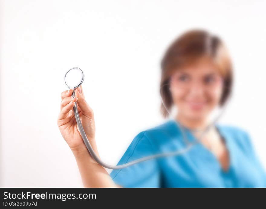 Medical doctor holding an stethoscope in focus on white background. Medical doctor holding an stethoscope in focus on white background