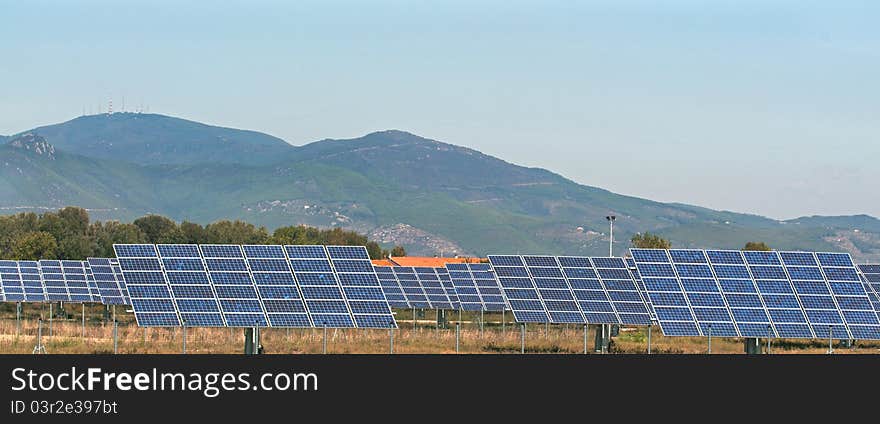 Photovoltaic panels in the country and field of sunflowers