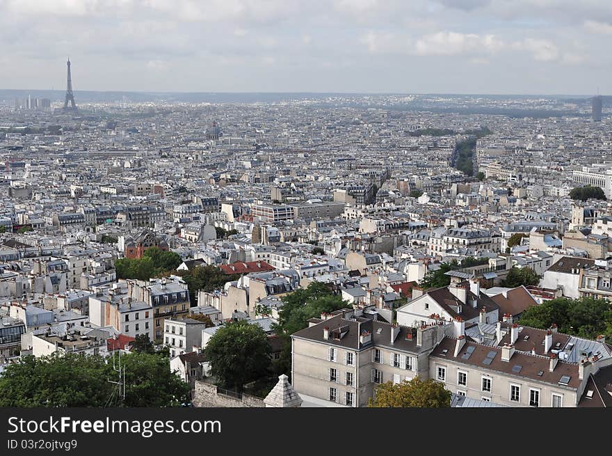 Paris skyline: Eiffel Tower from across Parisian rooftops.