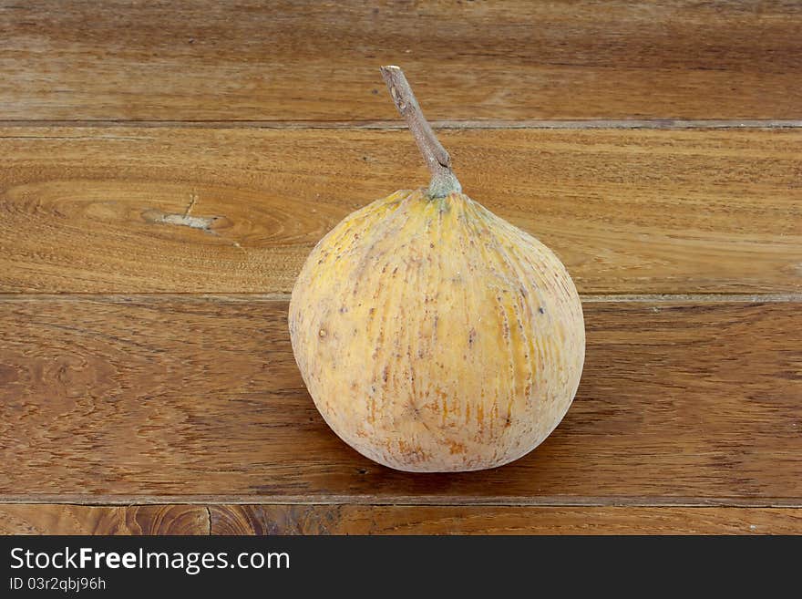 Single santol with teak wood background