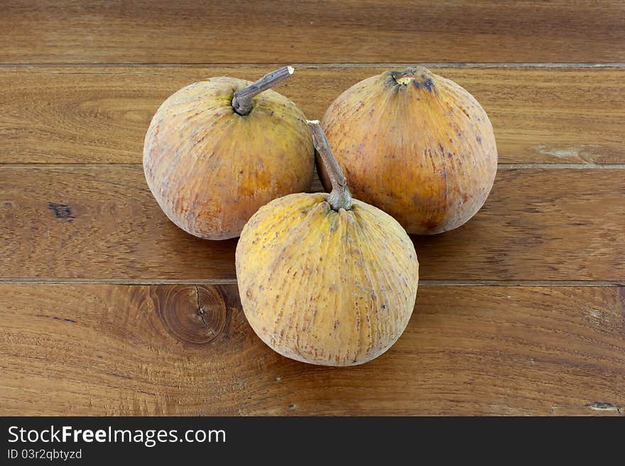 3 santol with teak wood background.