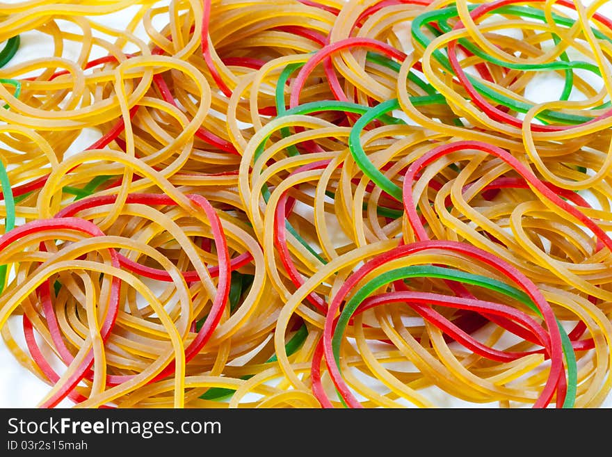 A pile of rubber bands on white background