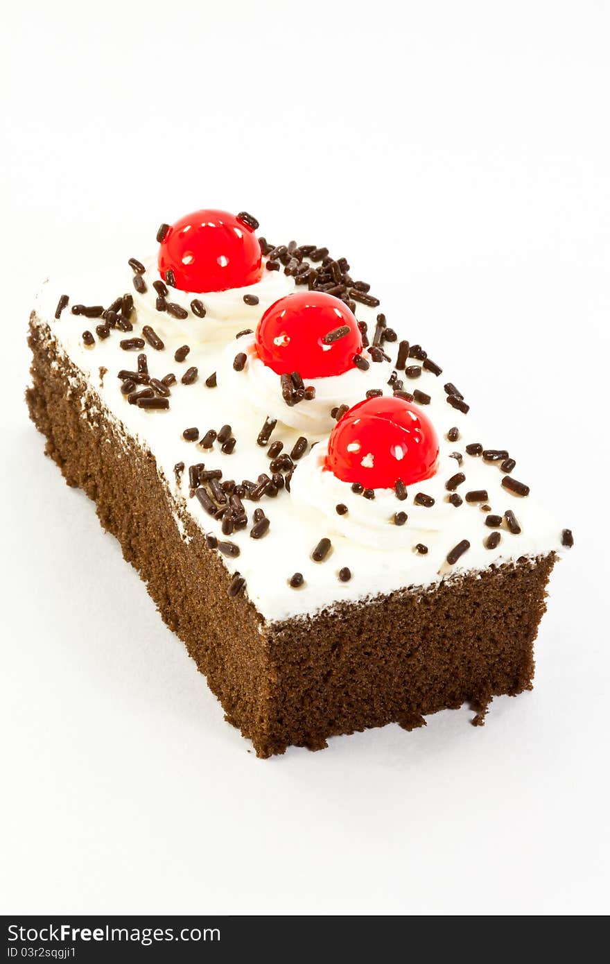 Chocolate cake garnished with cherries and chocolate chips