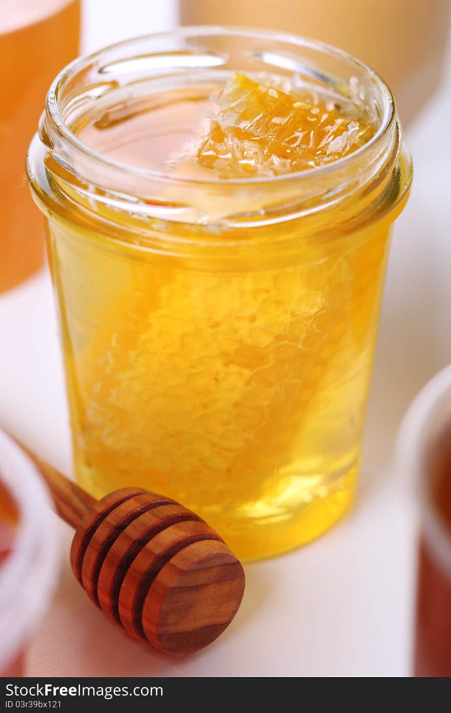 Jar of honey with honeycomb