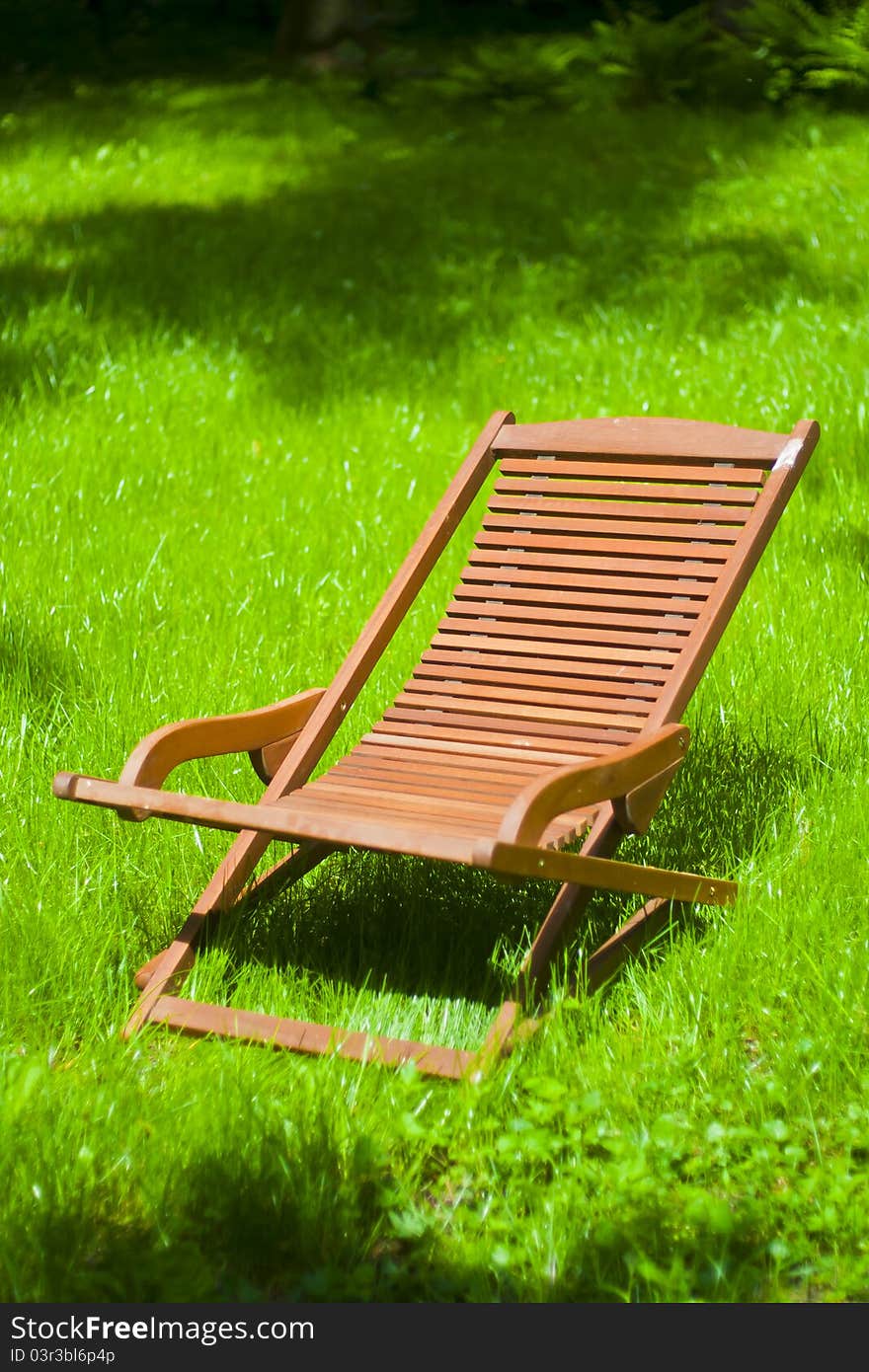 Chaise longue on the grass in bright day. Chaise longue on the grass in bright day