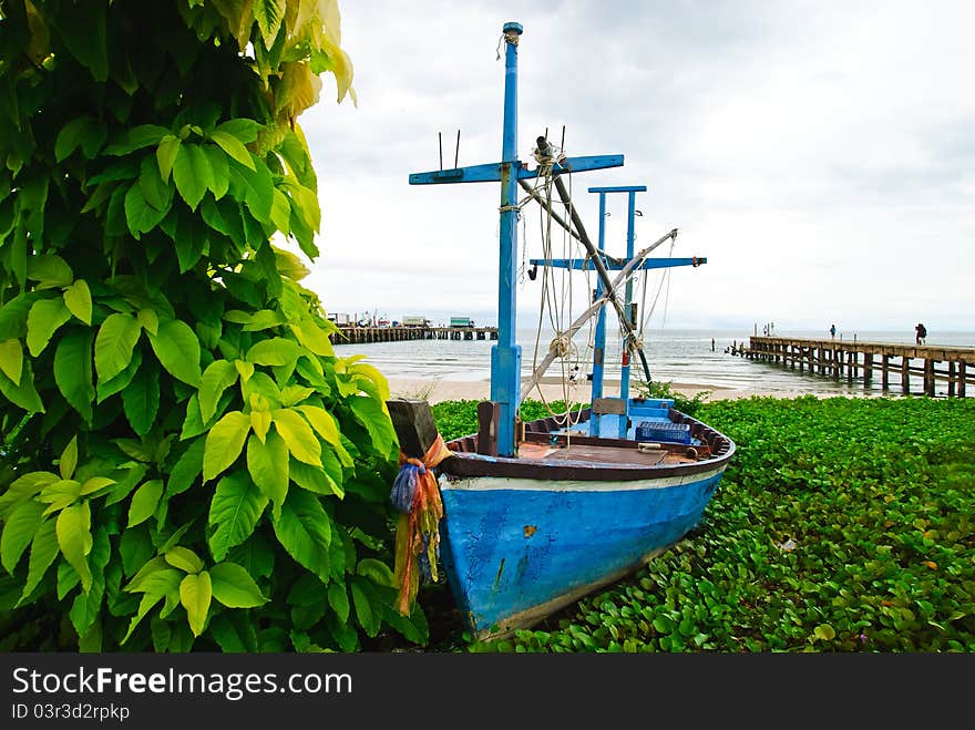 Fishing boat with leaf tree and sea background