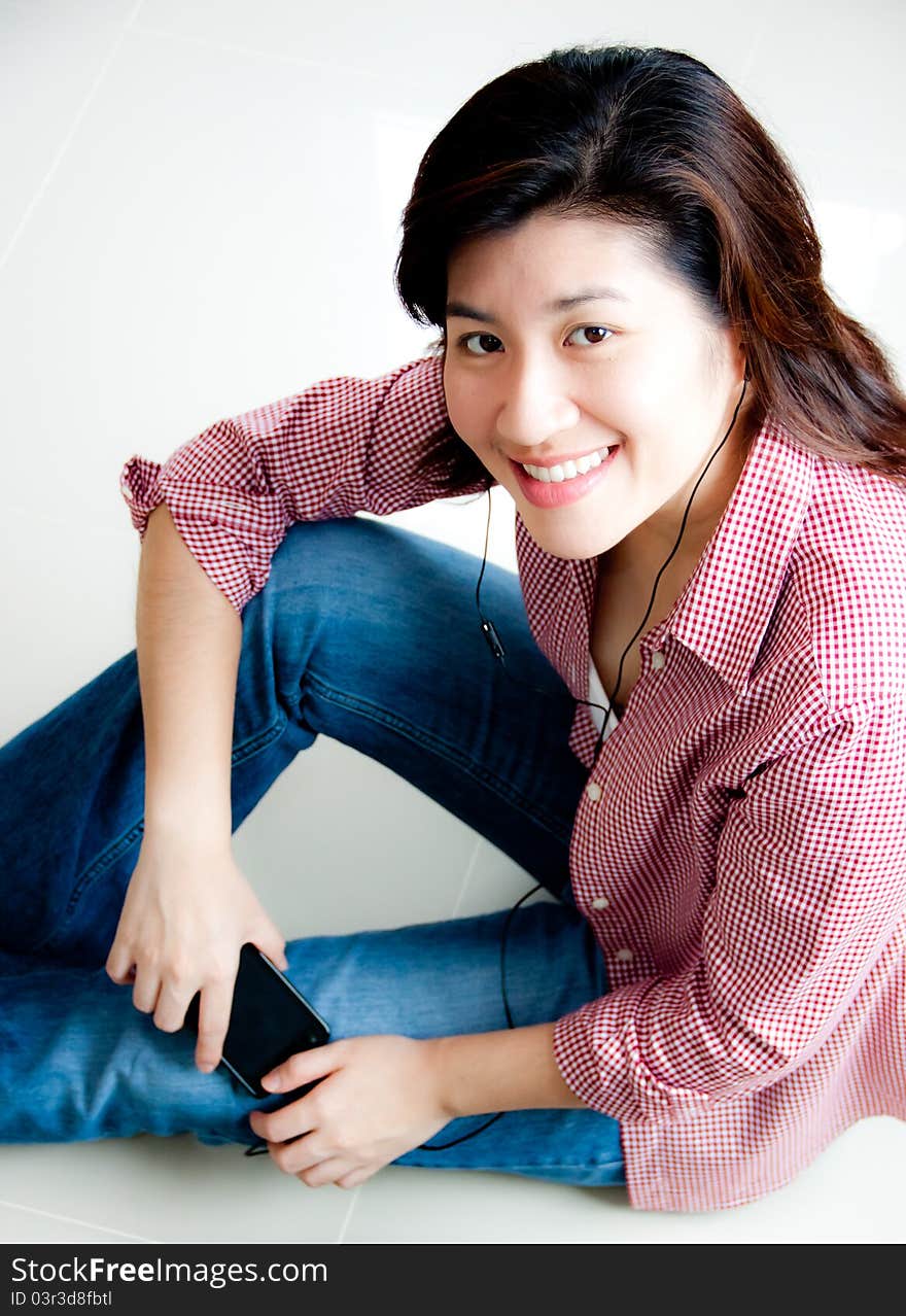 Portrait of beautiful asian woman sitting on the floor with mobile phone. Portrait of beautiful asian woman sitting on the floor with mobile phone