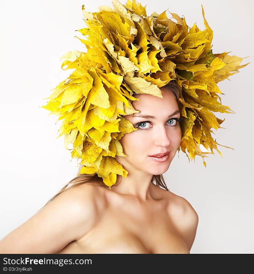 A girl with a wreath of autumn leaves. A girl with a wreath of autumn leaves.