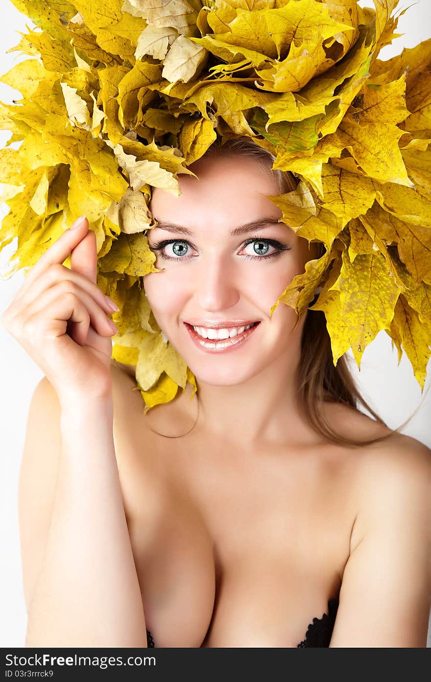 A girl with a wreath of autumn leaves. A girl with a wreath of autumn leaves.