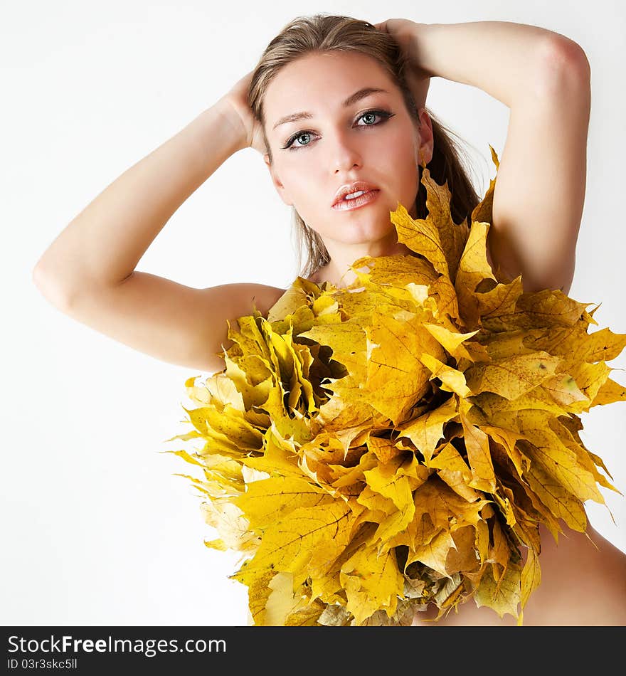 A girl with a wreath of autumn leaves. A girl with a wreath of autumn leaves.