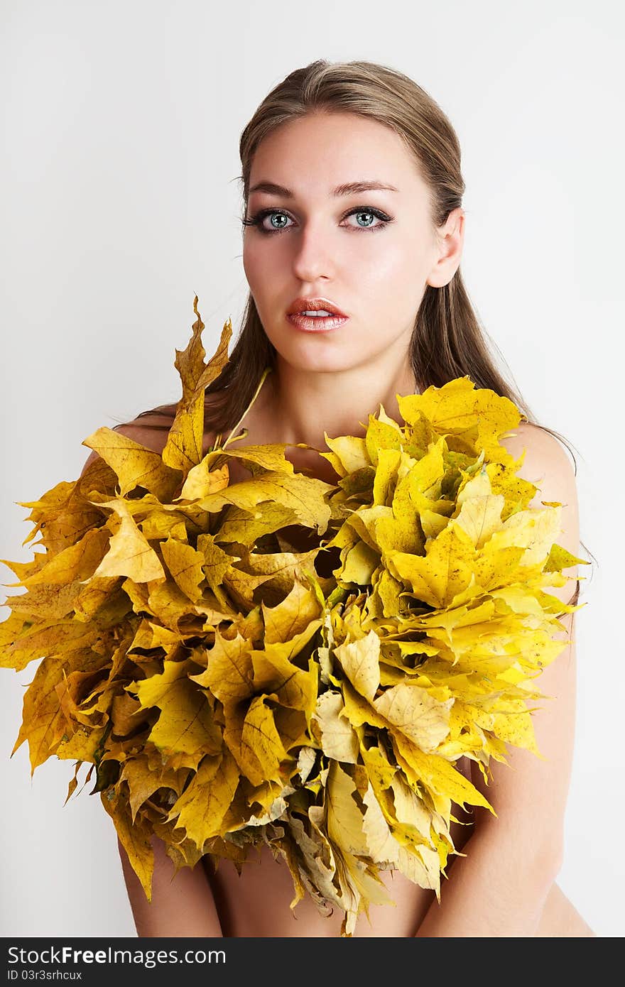 A girl with a wreath of autumn leaves. A girl with a wreath of autumn leaves.