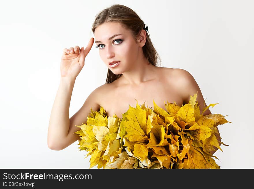 A girl with a wreath of autumn leaves. A girl with a wreath of autumn leaves.